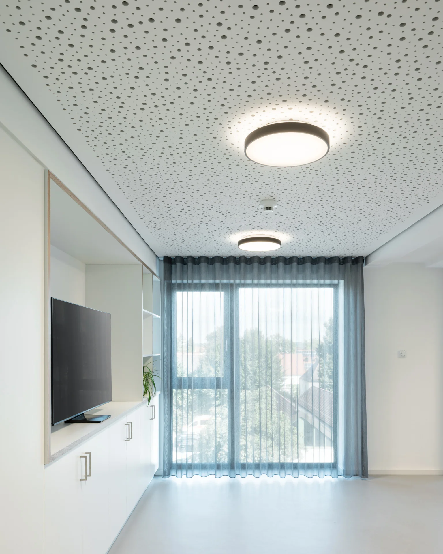Aufenthaltsbereich mit Medienwand und Fensterfront